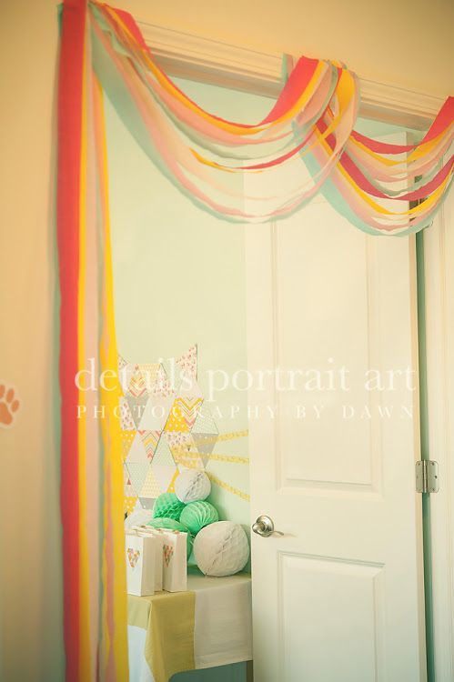 a room with a white door and some colorful streamers