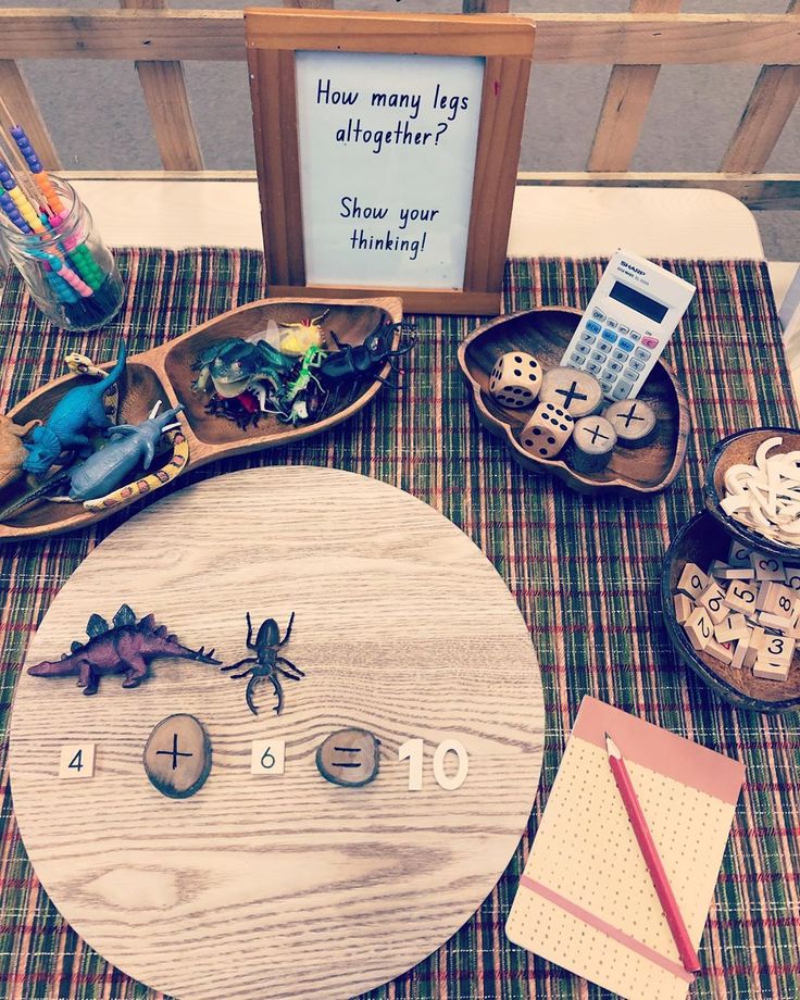 a wooden table topped with lots of different types of toys and decorations on top of it