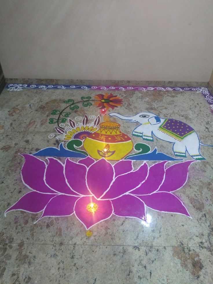 there is a decorated floor with flowers and elephants on it, next to a wall