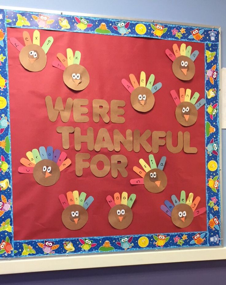 a bulletin board that says we're grateful for with handprints on it