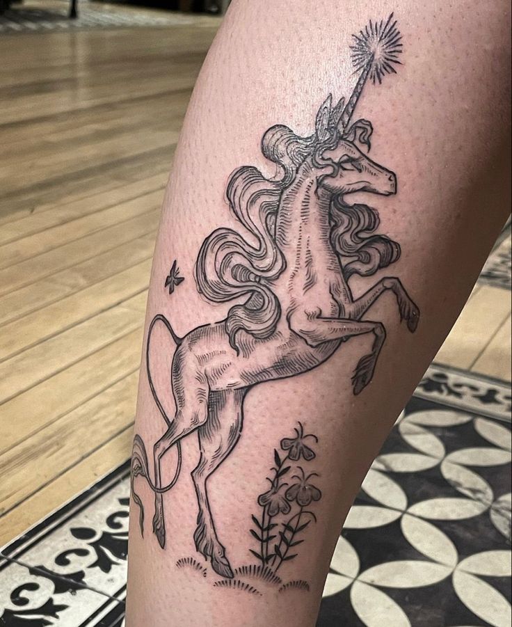 a black and white photo of a unicorn on the leg