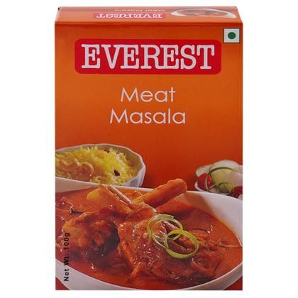 a box of meat masala with vegetables on the side