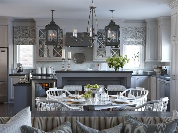 a kitchen and dining room are shown in this image, with white chairs around the table