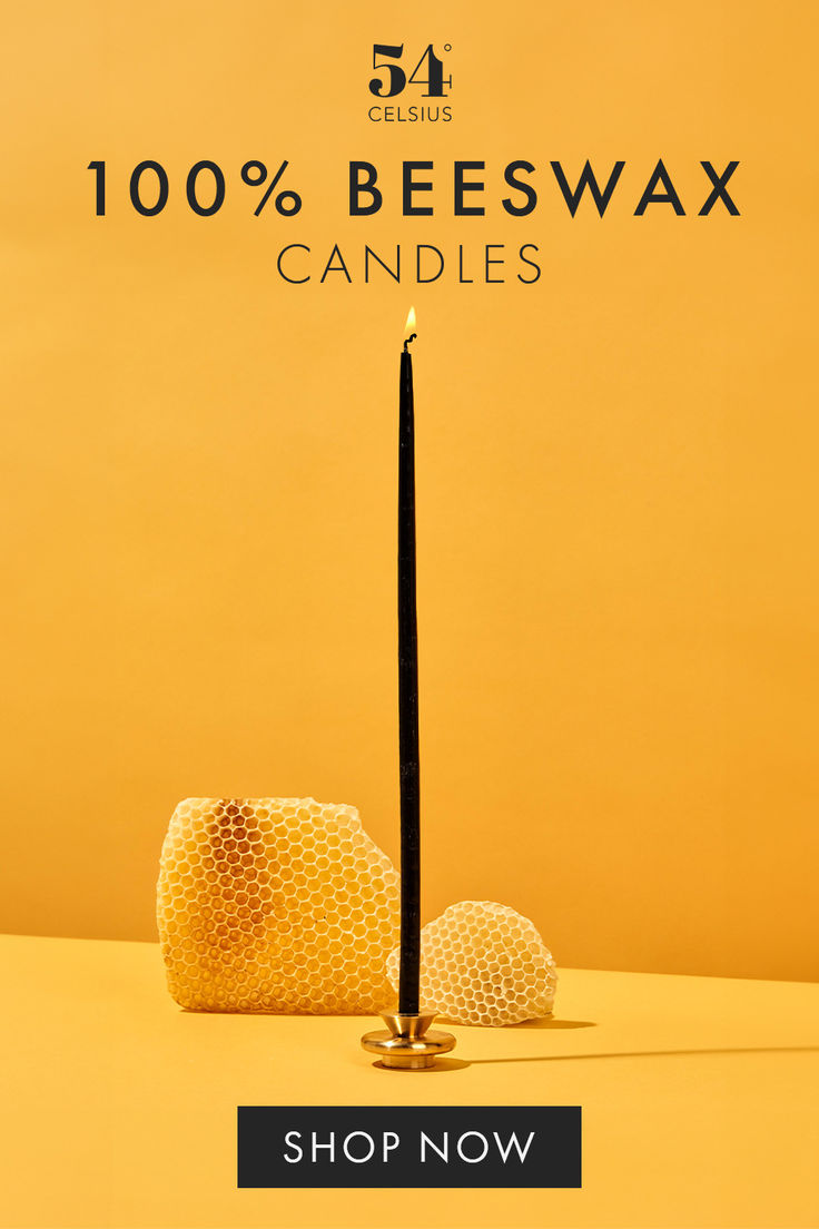 a candle that is on top of a table with the words, 100 % beeswax candles