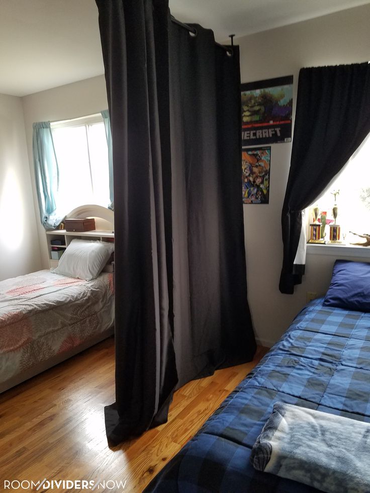 a bedroom with two beds and curtains in it