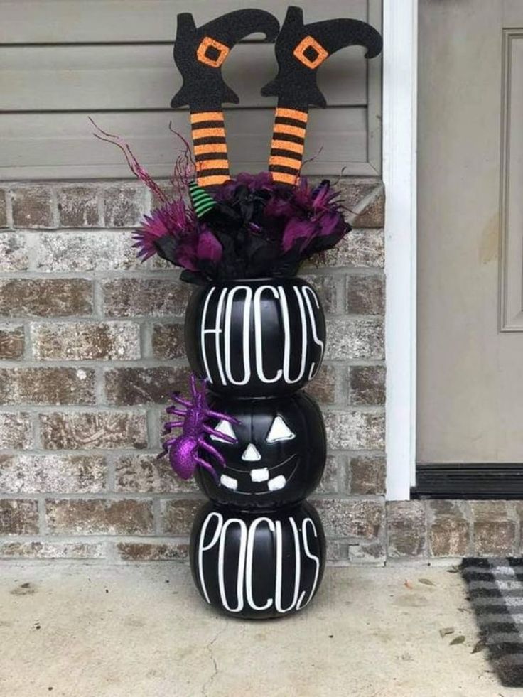 a black vase with halloween decorations on it