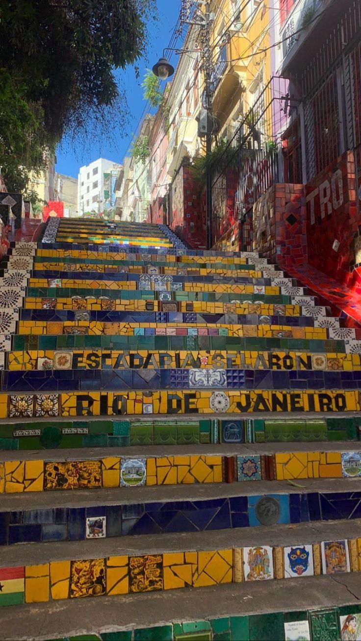 the stairs are painted with many different colors and designs, along with advertisements on them