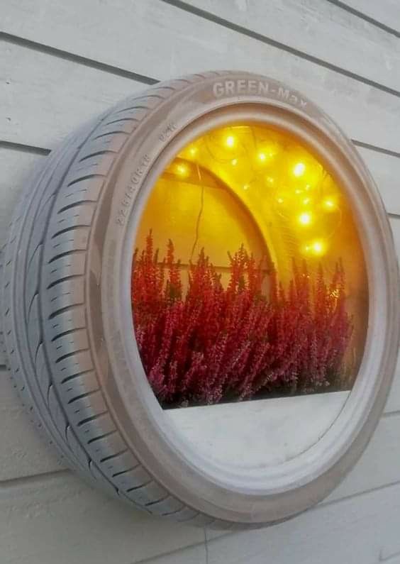 an image of a tire with lights in the reflection on it's side wall