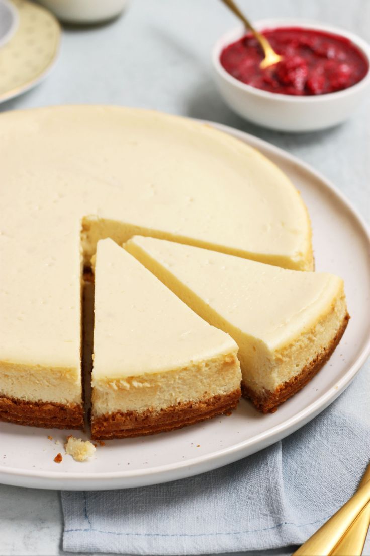 a cheesecake is cut into slices on a plate