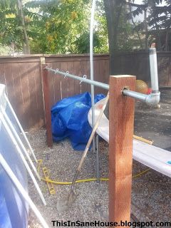 there is a blue tarp on the ground next to a wooden pole and fence