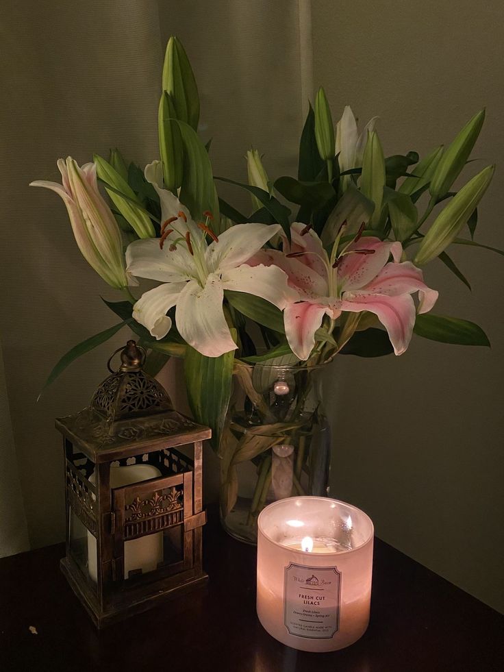 a candle and some flowers on a table