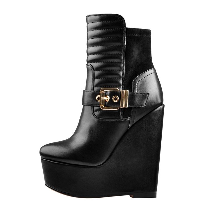 a pair of black boots with gold buckles