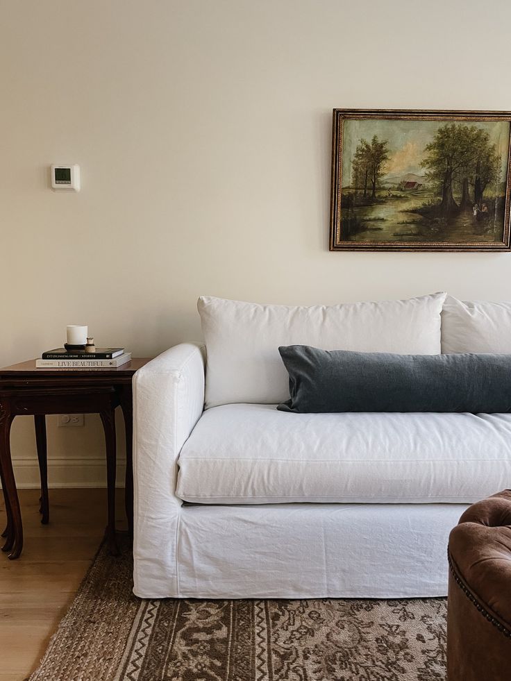 a white couch sitting next to a wooden table