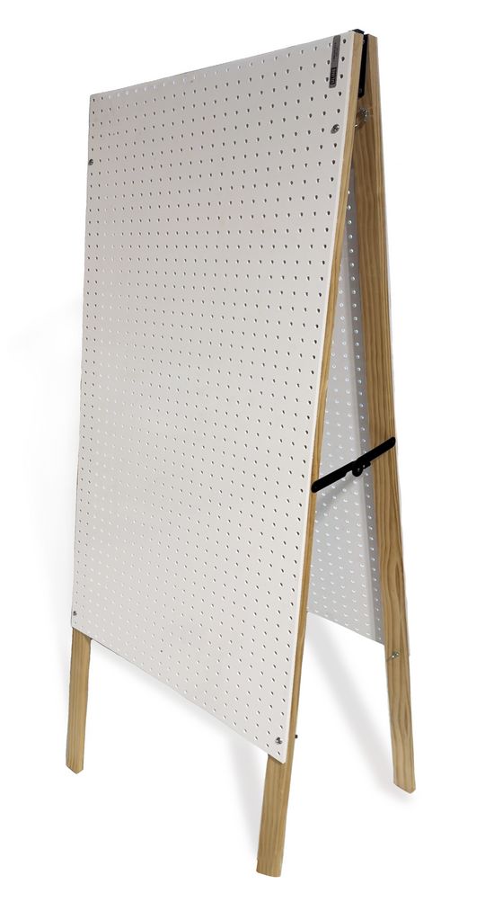 a white board with wooden legs and pegs on the bottom, in front of a white background