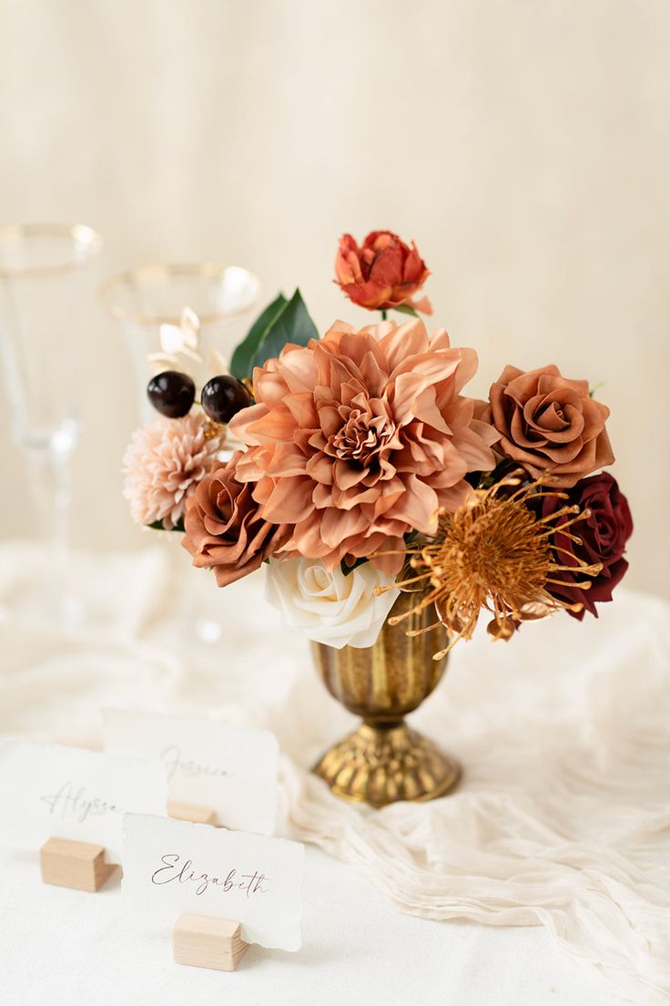 a vase filled with lots of flowers on top of a table