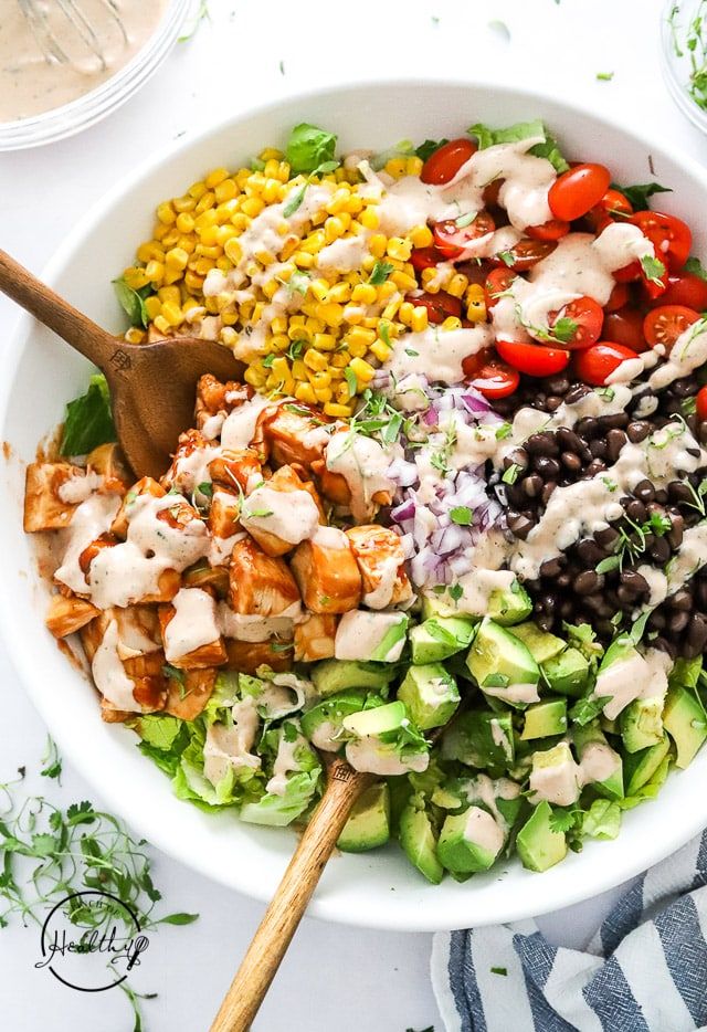 a large bowl filled with salad and dressing