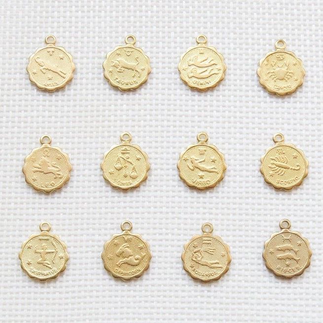 Our dainty zodiac coin necklace features a round scalloped pendant with a zodiac sign on it. …………………………………. Details: Pendant is Gold or Silver Plated over Brass measuring 12mm Chain is 14k Gold/Silver Plated, Gold Filled or Sterling Silver Average necklace length is 18" About Your Jewelry If you are not wearing your jewelry it is best to store it in a cool, dry place such as your gift box that is included in your ord 14k Gold Zodiac Sign Medallion Jewelry, Silver Zodiac Sign Jewelry Gold Plated, Yellow Gold Zodiac Sign Jewelry, Celestial 14k Gold Coin Pendant Jewelry, Celestial Jewelry With Round Pendant Charms, Yellow Gold Coin-shaped Charms Jewelry, Yellow Gold Coin-shaped Jewelry With Charms, Yellow Gold Coin Shaped Jewelry With Charms, Celestial Zodiac Sign Gold-plated Jewelry