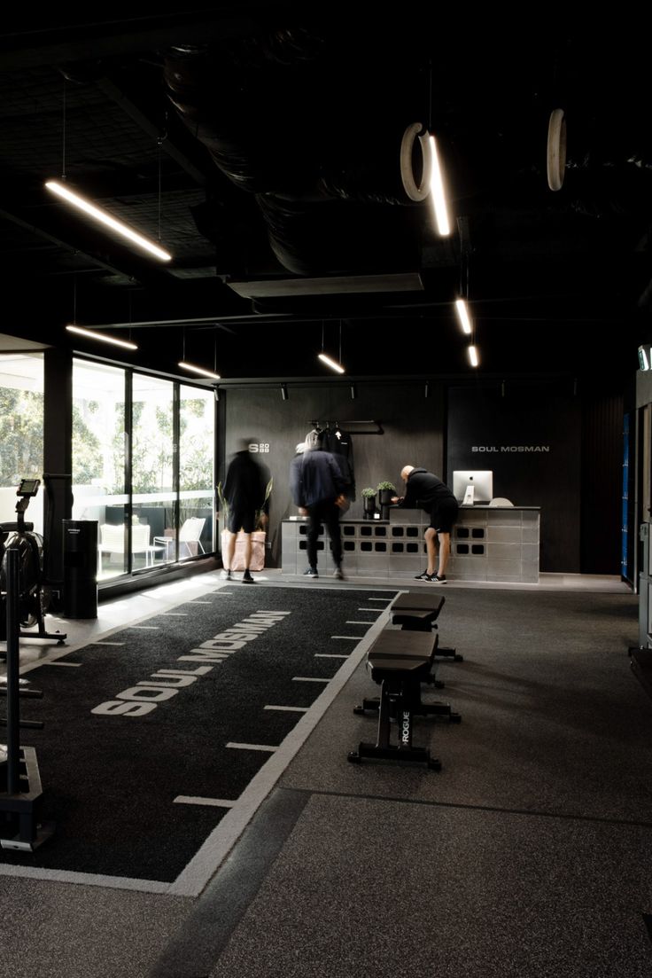 people are walking through an empty gym