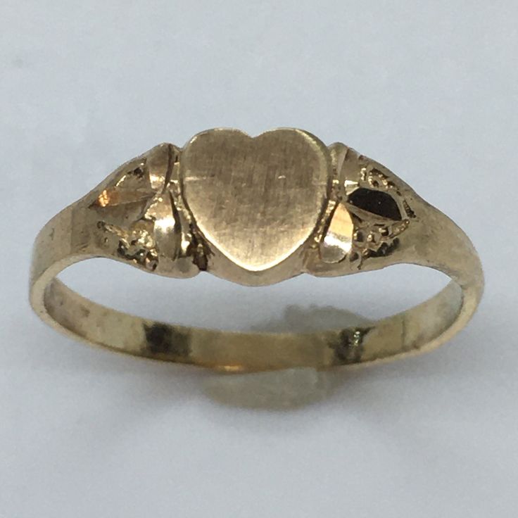 Antique Heart Shape 14K GOLD Signet RIng 1.0 Gram Size 5.25 Never Engraved This antique signet ring is a true beauty. Crafted from 14k yellow gold, it features a heart-shaped design that exudes elegance and sophistication. The ring is perfect for any occasion and is a great addition to any jewelry collection. With a weight of 1.0 gram and a size of 5.25, this ring is a perfect fit for anyone. It has never been engraved and does not feature any diamonds or gemstones. The vintage design adds to its charm and makes it a unique piece. Don't miss out on the opportunity to own this exquisite piece of fine jewelry. 6 mm wide on top Classic Heart-shaped Signet Ring For Wedding, Heirloom 14k Gold Heart Promise Ring, Victorian Yellow Gold Jewelry For Valentine's Day, Vintage Promise Jewelry For Valentine's Day, Classic Heart Cut Signet Ring For Promise, Classic Oval Heart Ring For Valentine's Day, Antique Yellow Gold Heart Cut Jewelry, Victorian 14k Gold Jewelry For Valentine's Day, Heirloom Oval Rings For Valentine's Day