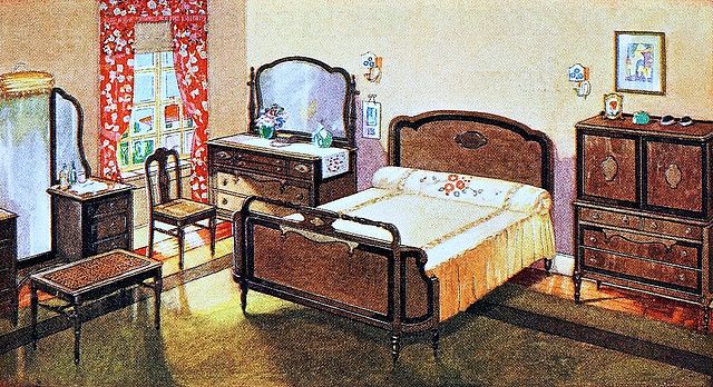 a bedroom scene with a bed, dressers and a mirror on the wall above it