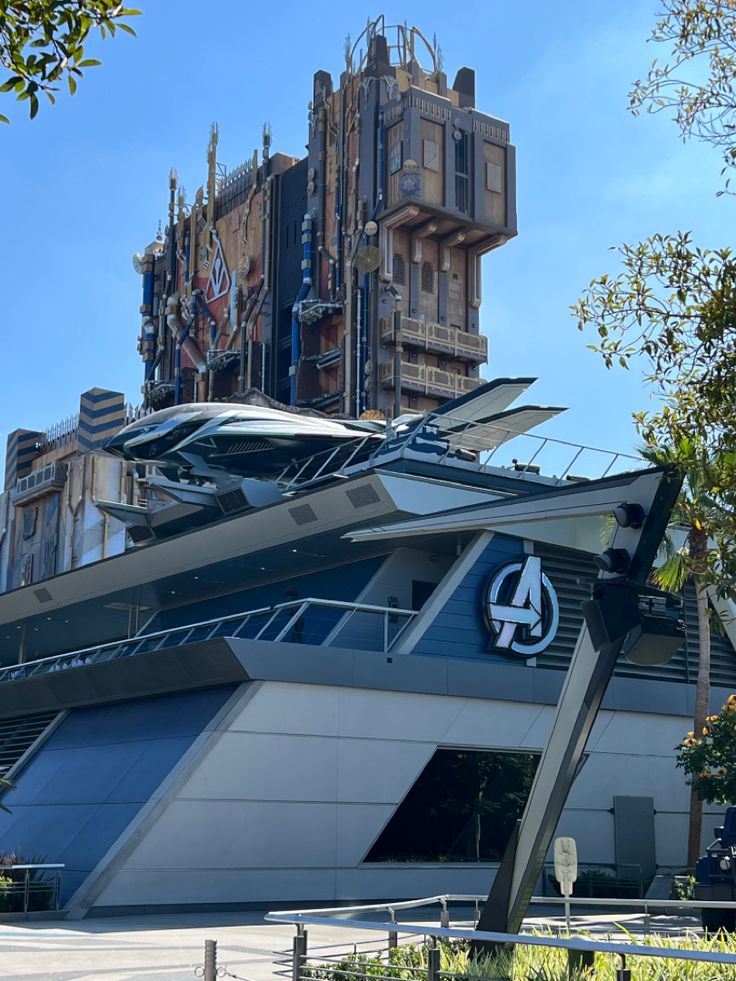 the avengers logo is displayed on the side of a building in front of a blue sky