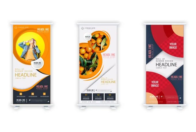 three roll up banners with an orange and blue design on the front, two are white and one is red