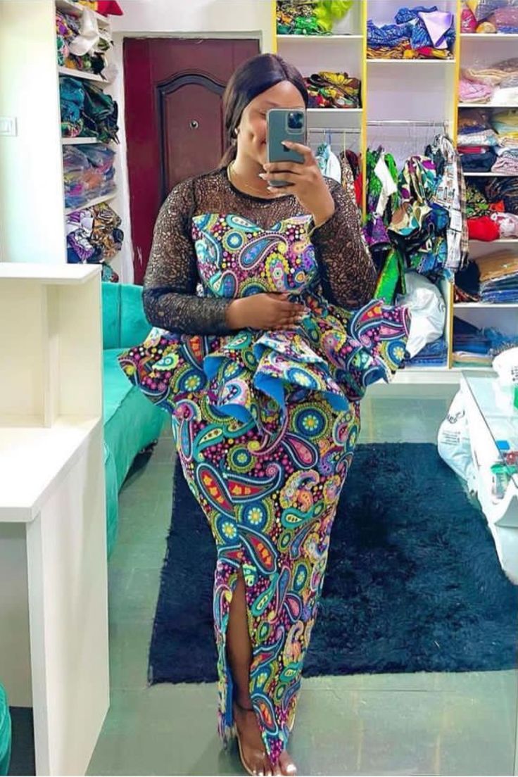 A lady wearing an Ankara skirt and blouse with slit Skirt With Peplum Top, Blouse Styles For Women, Peplum Top With Skirt, Ankara Top And Skirt, Ankara Jumpsuit Styles, Peplum Top Outfits, Ankara Skirt Styles, Ankara Skirt And Blouse Styles, Jumpsuit Styles