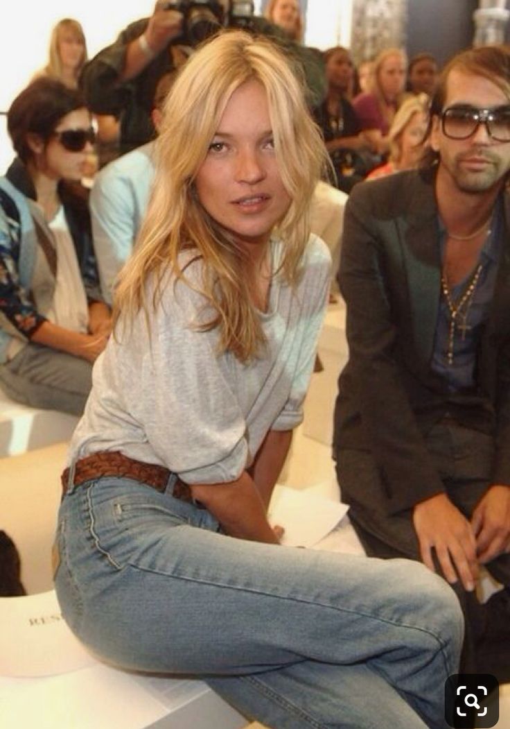 a woman sitting on top of a white bench next to a man