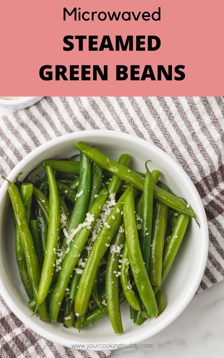 green beans in a white bowl with parmesan cheese on top and text overlay that reads microwave steamed green beans