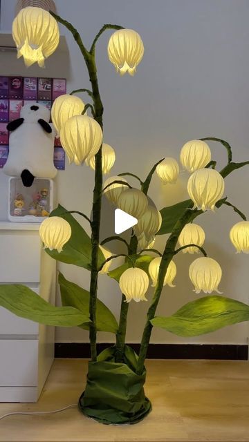 a vase filled with white flowers on top of a wooden table