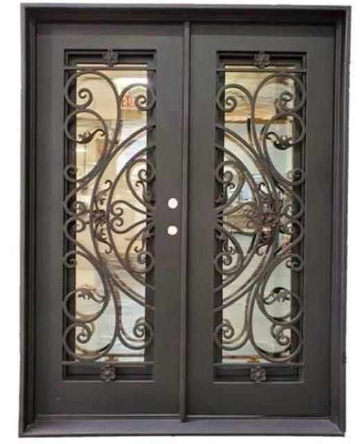 an iron door with glass panels on the front and side doors, which have decorative designs