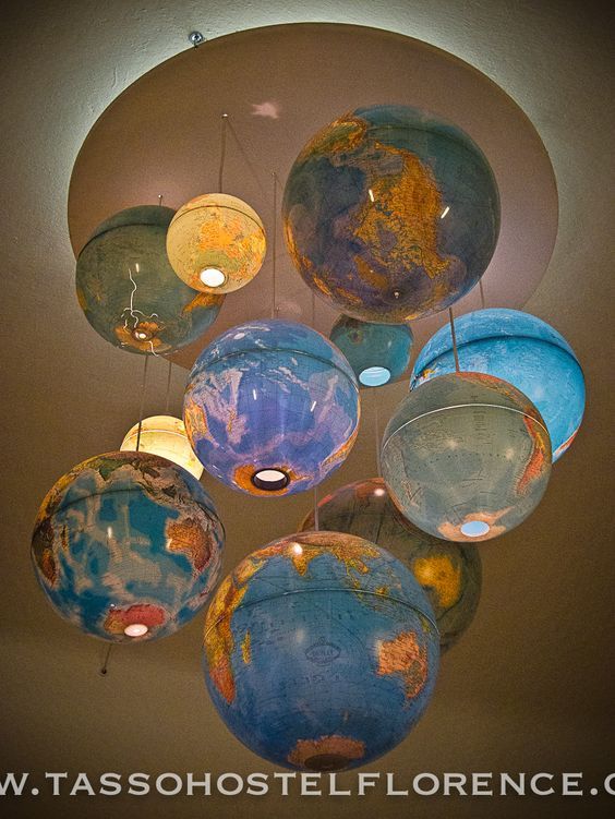 a chandelier made out of globes hanging from the ceiling