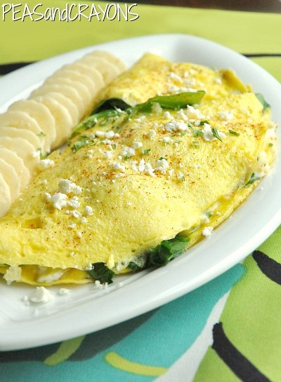 an omelet with spinach and cheese on a plate