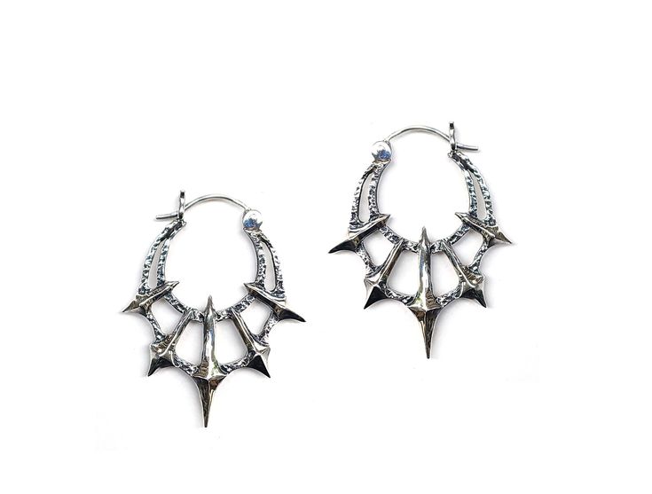 Add some gothic style to your wardrobe with these unique Chaos Earrings. Made in sterling silver, these earrings feature 5 spikes contrasted by a heavy textured crescent. Dimensions These earrings are 45mm long x 36mm wide and 5mm thick Each earring weighs approximately 6.5grams Edgy Sterling Silver Earrings, Edgy Sterling Silver Pierced Earrings, Punk Style Silver Pierced Earrings, Edgy Handmade Silver Earrings, Punk Style Silver Jewelry With Silver Studs, Punk Style Sterling Silver Pierced Earrings, Edgy Silver Sterling Silver Plug Earrings, Silver Punk Pierced Earrings, Edgy Sterling Silver Plug Earrings