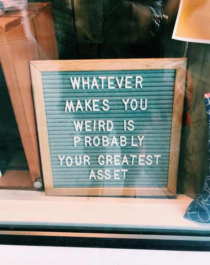 a sign that says whatever makes you weird is probably your greatest asset on display in a store window