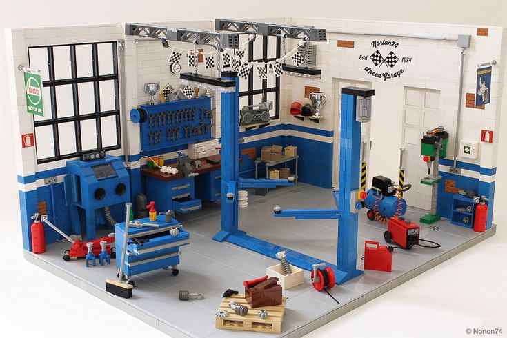 a lego model of a garage with tools on the workbench and other items