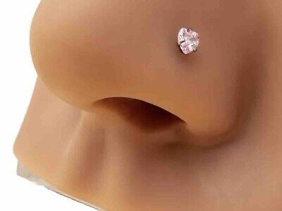 a white diamond ring on top of a mannequin's head with no hair