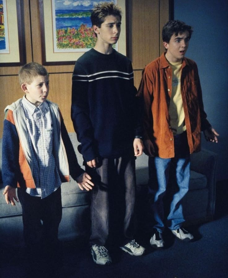 three young men standing next to each other