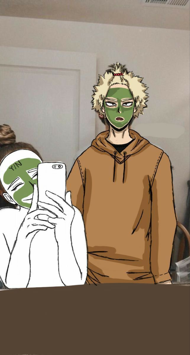 two people with face masks are looking at a cell phone