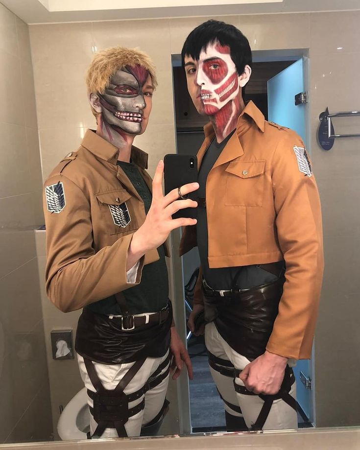 two men in costumes are taking a selfie