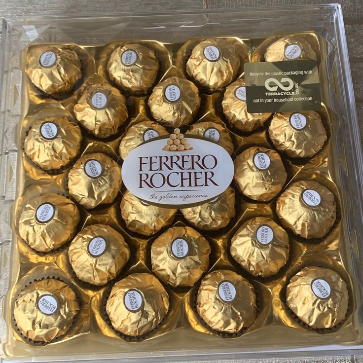 a box filled with gold foil wrapped chocolates