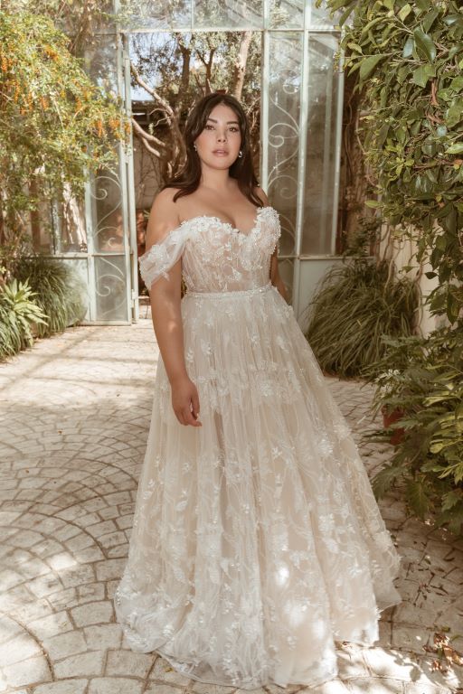 a woman in a wedding dress posing for the camera