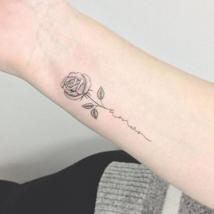 a woman's arm with a rose tattoo on the left side of her arm