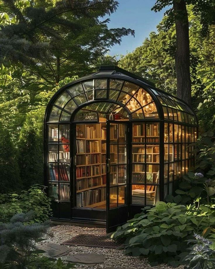 an image of a glass house in the woods with lots of books on it's shelves