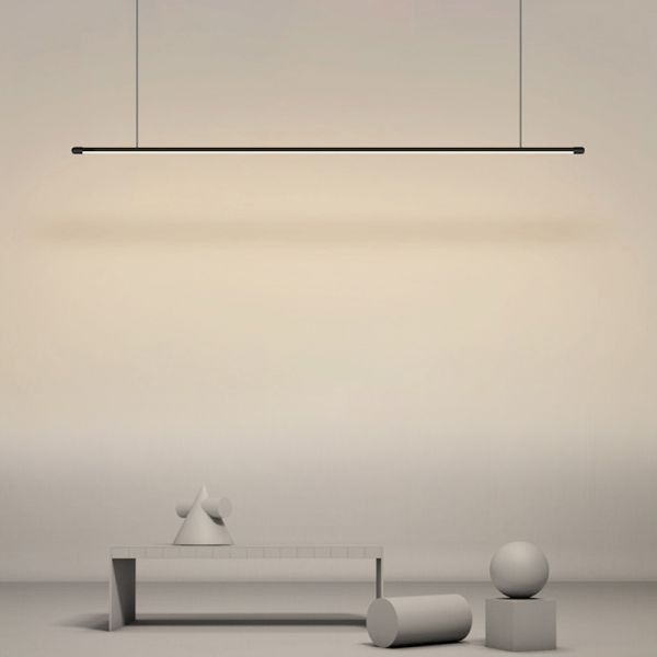 an empty room with some white objects on the floor and a suspended light above it