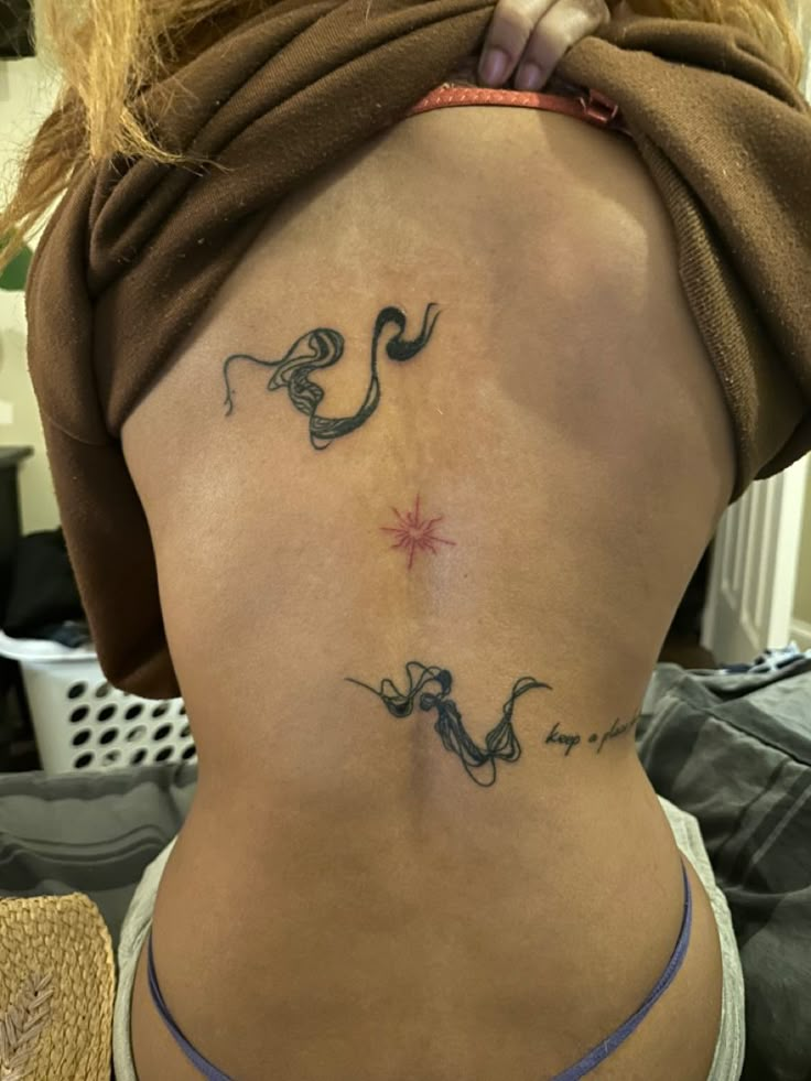 a woman with a tattoo on her back