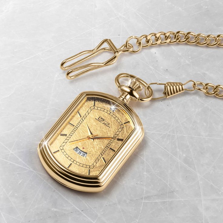 The pocket watch is a classic, elegant style. It has been around for hundreds of years and remains timeless and classy—the ultimate status symbol for men. A fancy rectangular case is set with a 24k gold foil dial that is sure to impress. A single solitaire Diamondeau®, flawless simulated diamond sits at 12 o’ clock and handy date window to keep you on track. Get yourself a piece of history with this gold foil pocket watch. Classic Elegant Style, Status Symbol, Gold Pocket Watch, Latest Jewellery, Classic Elegant, Mens Gold, Signature Design, Gold Foil, Elegant Style