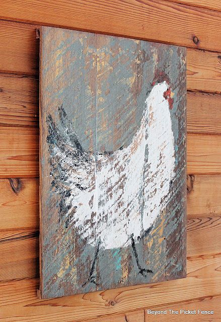 a chicken painted on a wood paneled wall