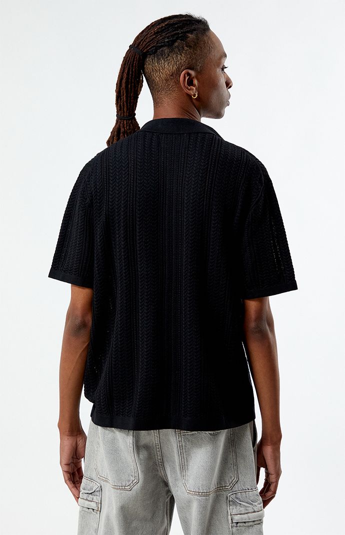 Introducing the Cropped Knit Camp Shirt from PacSun, the perfect blend of comfort and style. Crafted from a cozy knit fabrication, this shirt offers a soft and comfortable feel for everyday wear. With its collared neckline, short sleeves, and standard fit, it provides a classic and versatile look. Complete with button closures, it adds a touch of sophistication to any outfit. 


	Collared neckline
	Short sleeves
	Cropped fit
	Knit textured fabrication
	60% Cotton, 20% nylon, 20% viscose
	Machine washable 
	Model is wearing size medium
	Model Measurements: 6'1” Height, 31” Waist, 32” Inseam Relaxed Fit V-neck Pointelle Knit Top, Cotton Polo Sweater With Textured Knit And Relaxed Fit, Relaxed Fit Textured Knit Collared Sweater, Collared Sweater With Textured Knit And Relaxed Fit, Textured Knit Relaxed Fit Collared Sweater, Textured Knit Collared Sweater With Relaxed Fit, Casual Cotton Polo Sweater With Textured Knit, Casual Relaxed Fit Tops With Ribbed Collar, Casual Relax Fit Top With Ribbed Collar