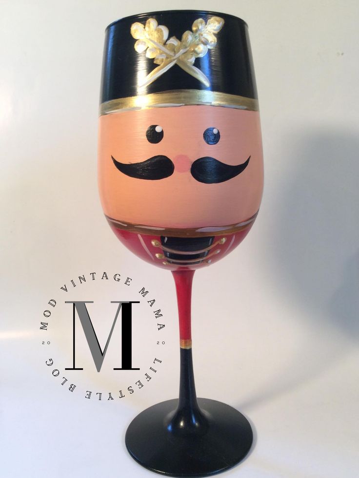 a painted wine glass with a mustache on it